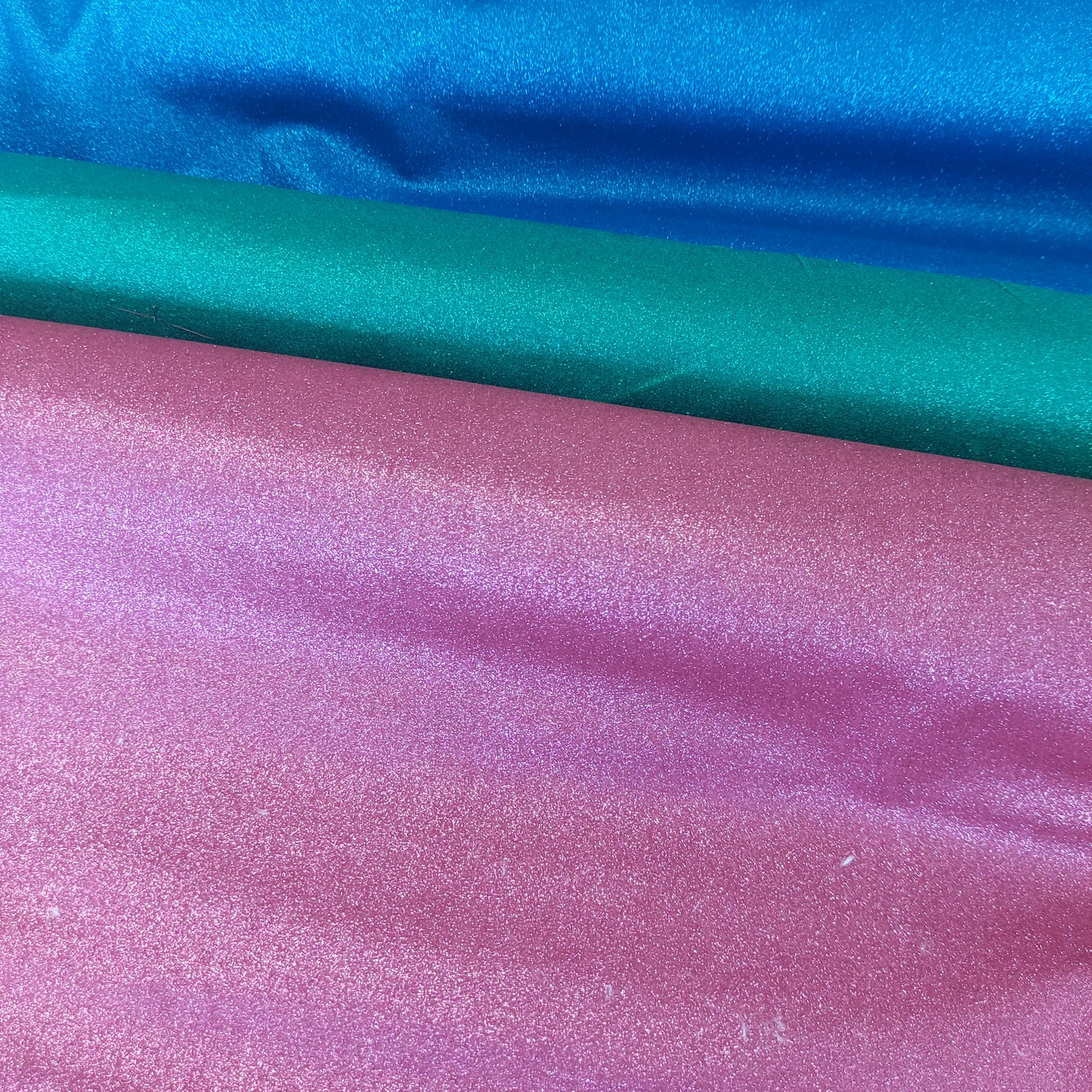 57" wide Stardust Sparkle Glitter textured Cotton, green, pink & Blue. Sold per HALF meter